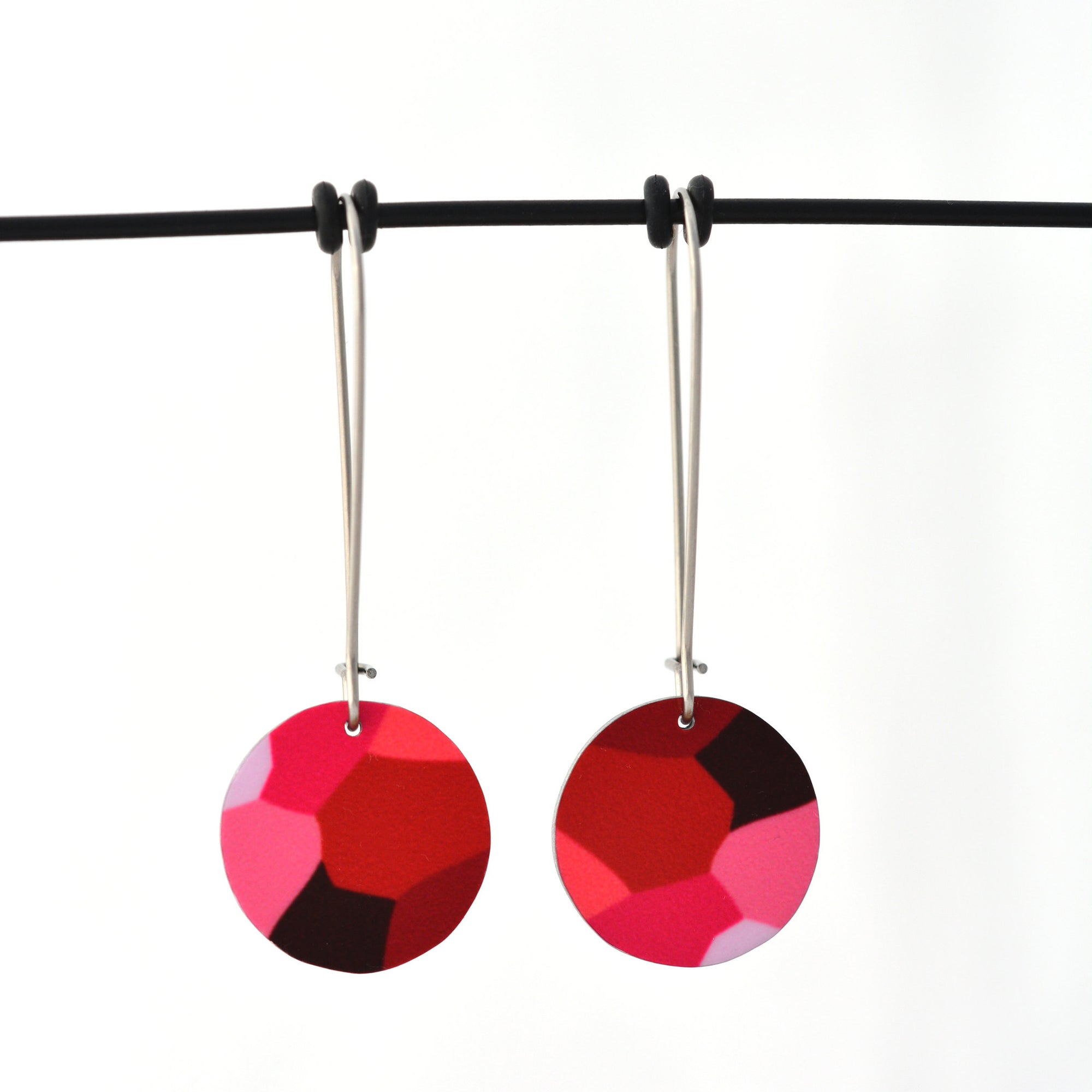 Pink facets circle earrings; designed from the organic details inside Geraldton Wax flowers. Approximately 16mm in diameter. Aluminium, with surgical stainless steel drop hooks approximately 33mm in length.