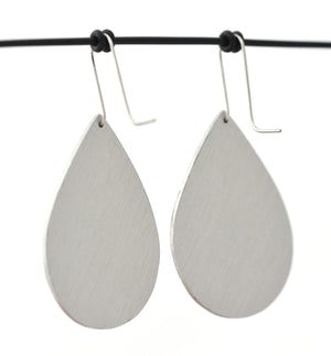 Brushed aluminium rear of droplet earrings featuring details from a monarch butterfly wing. The aluminium earrings are approximately 40mm long and 29mm wide. The 15mm long shepherds hooks are surgical stainless steel.