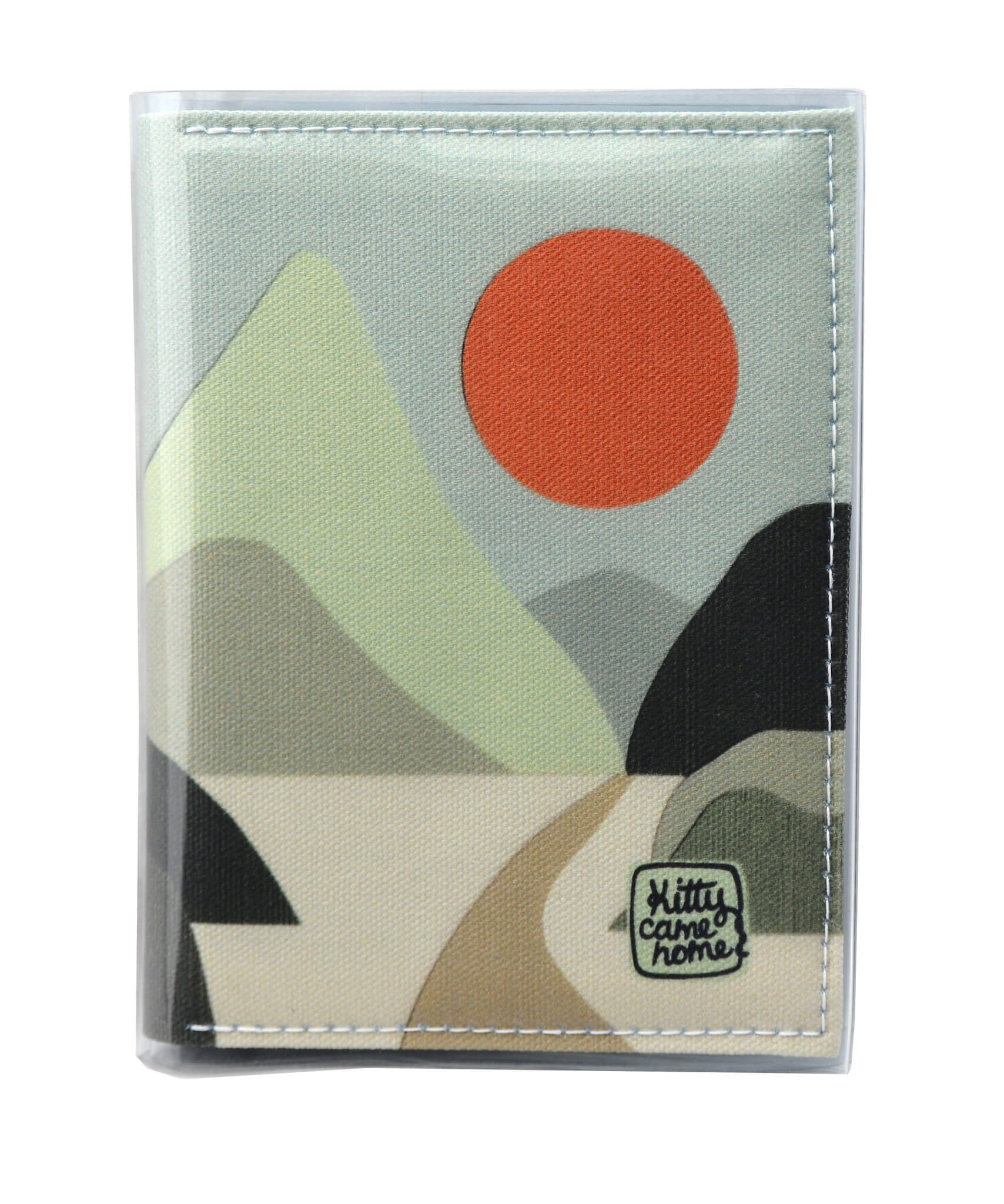 This is an image of the front of a Kitty Came Home A6 journal in the 'Moonlight drive’ design by Satin and Tat. An orange sun in a pale green sky above a landscape of green hued hills. A path leads between the hills toward the distant mountains.