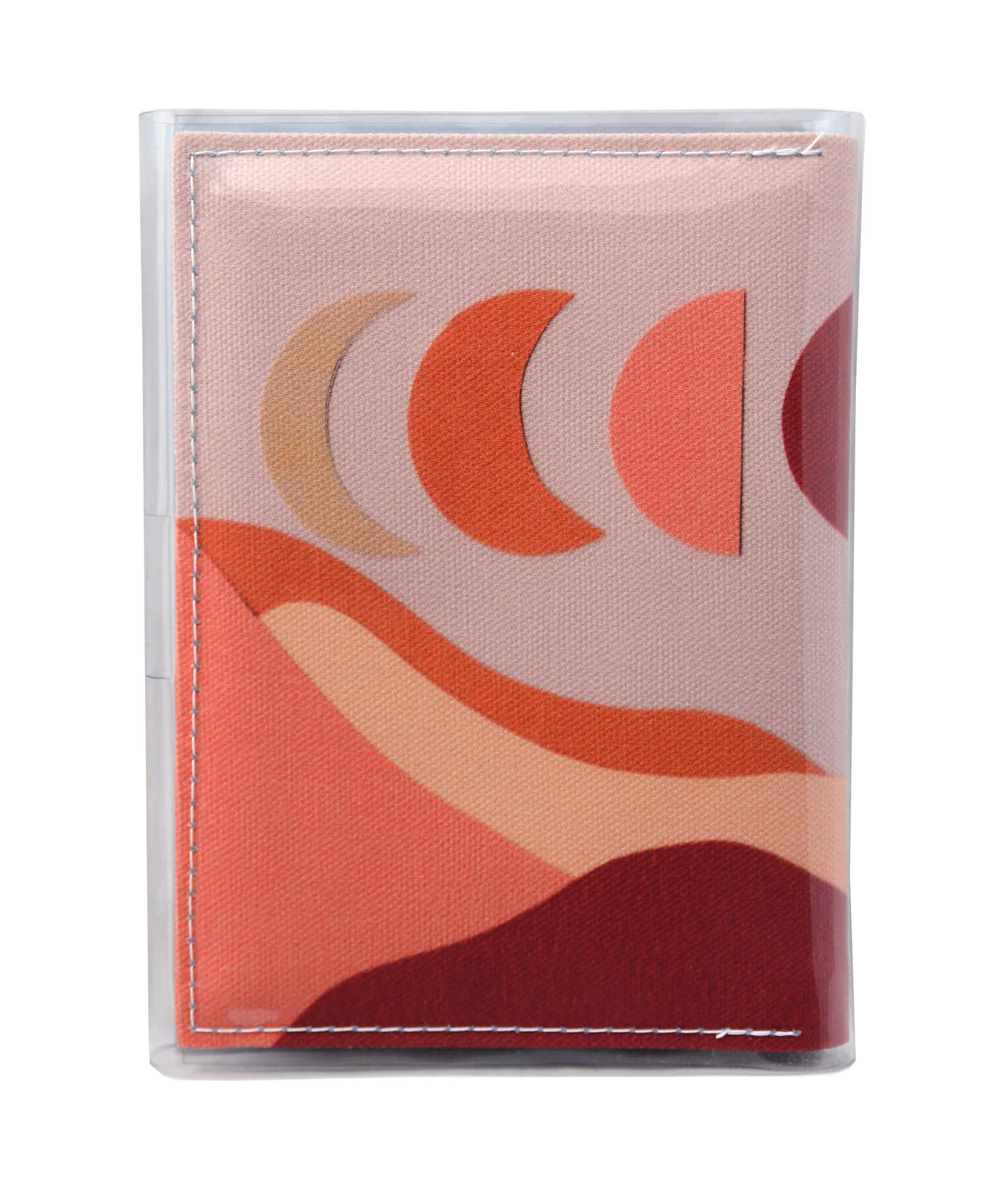 This is an image of the rear of a Kitty Came Home A6 journal in the 'Moonshadow drive’ design by Satin and Tat. The moon appears in all its phases in a dusty pink sky above a landscape lit by the moon's colours: burgundy, oranges, and apricot.