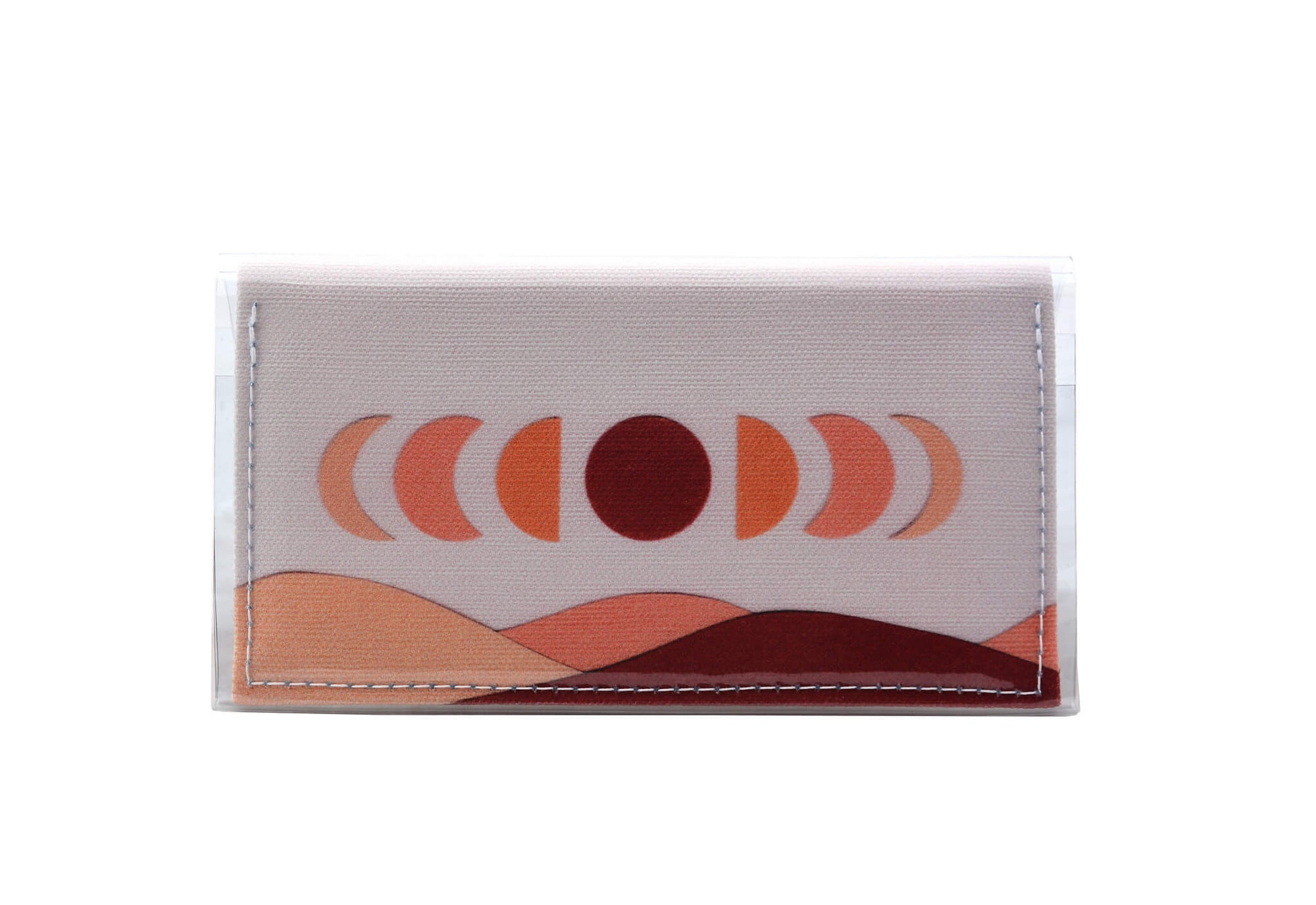 This is an image of the rear of a Kitty Came Home bifold mini purse clutch in 'The same moon shines' design by Satin and Tat. The moon appears in all its phases in a white sky above a landscape lit by the moon's colours: burgundy, oranges and apricot. This is the small size.