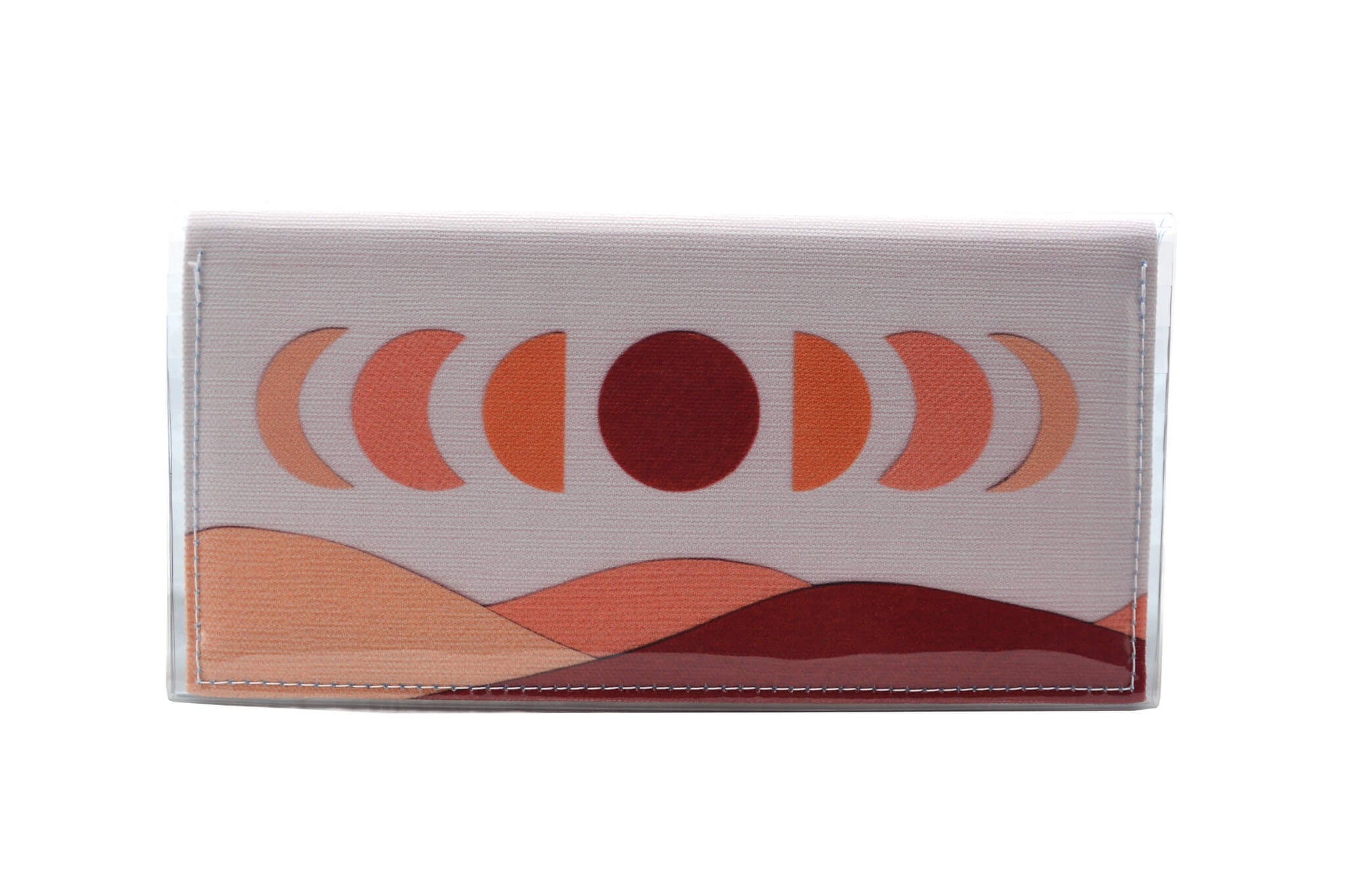 This is the image of the rear of a Kitty Came Home bifold plus purse clutch in 'The same moon shines' design by Satin and Tat. The moon appears in all its phases in a white sky above a landscape lit by the moon's colours: burgundy, oranges and apricot. This is the large size. 