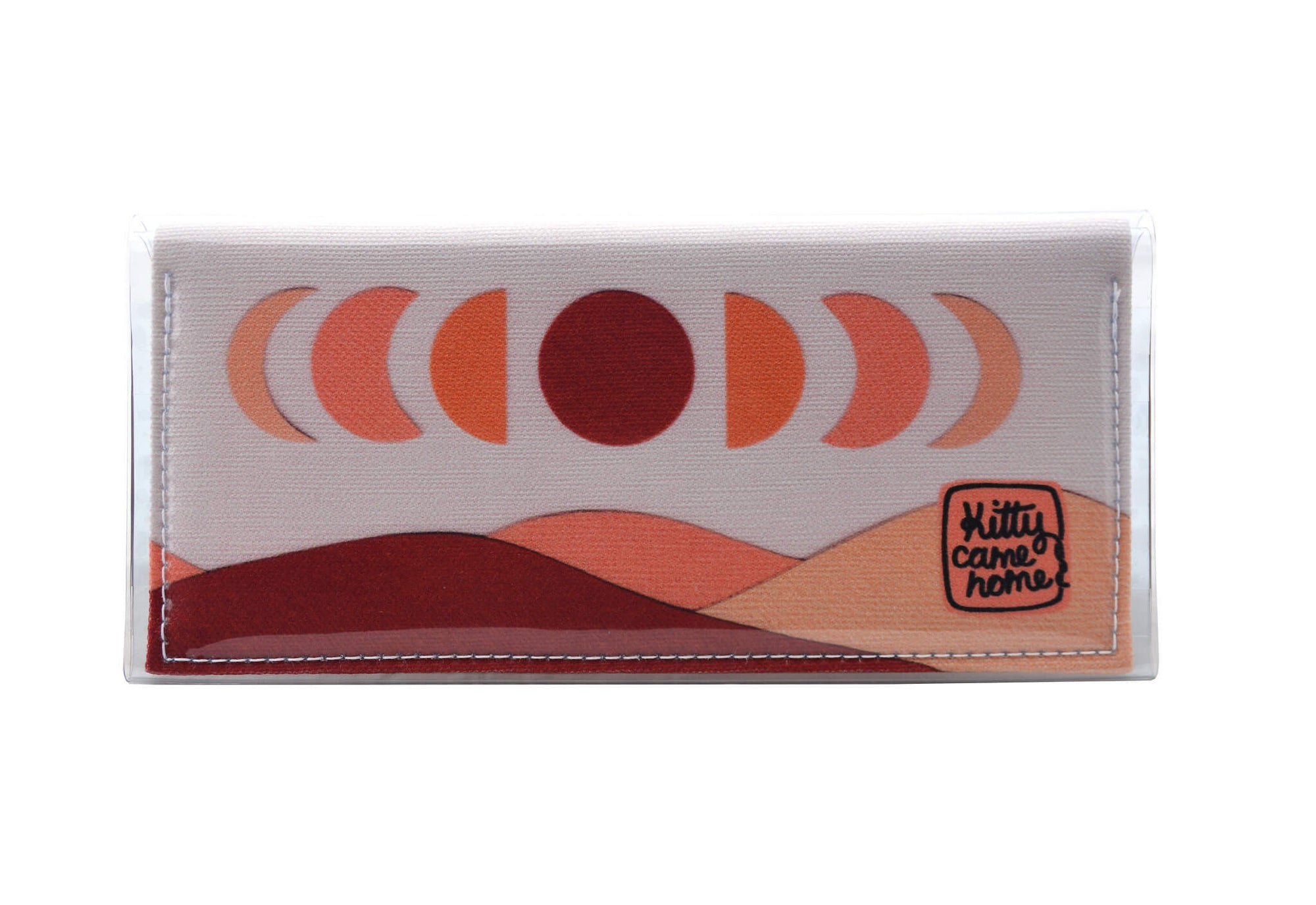 This is an image of the front of a Kitty Came Home bifold purse clutch in 'The same moon shines' design by Satin and Tat. The moon appears in all its phases in a white sky above a landscape lit by the moon's colours: burgundy, oranges and apricot. This is the standard size.